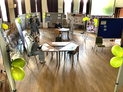 Schülerinnen und Schüler besuchen die interaktive Ausstellung in der Aula